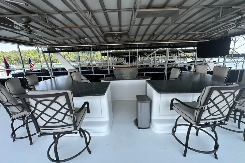 Slide: The Image of Luxurious 2003 Sumerset 18x86 houseboat deck with bar seating and scenic lake view. - 22
