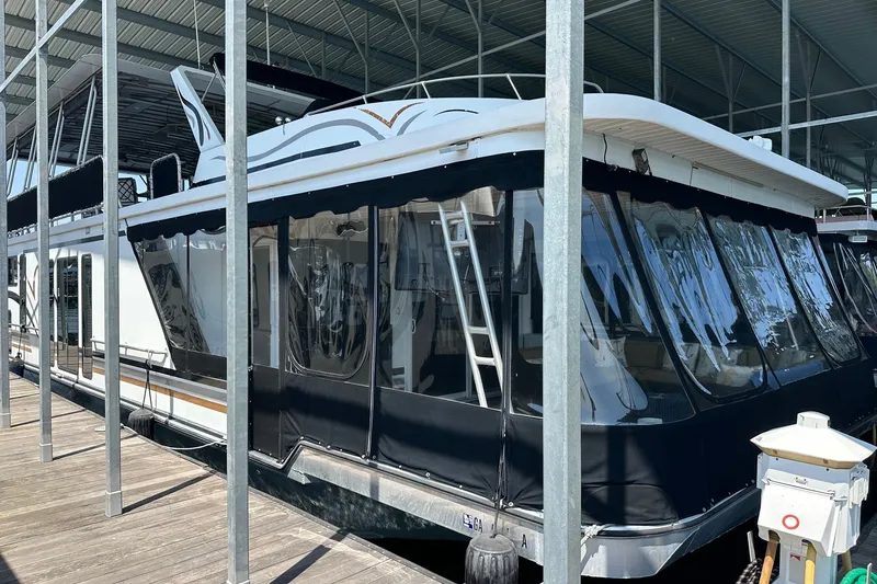 The Image of 2003 Sumerset 18x86 houseboat docked under a covered marina. - 0