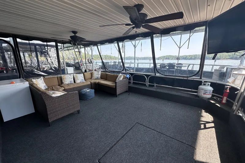 Slide: The Image of Spacious 2003 Sumerset 18x86 houseboat interior with cozy seating and scenic lake views. - 1