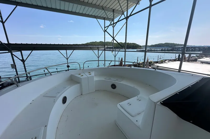 Slide: The Image of 2003 Sumerset 18x86 houseboat deck with lake view and covered seating area. - 20