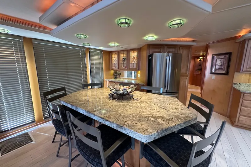 Slide: The Image of Luxurious kitchen interior of 2003 Sumerset 18x86 houseboat with granite countertops and modern appliances. - 5