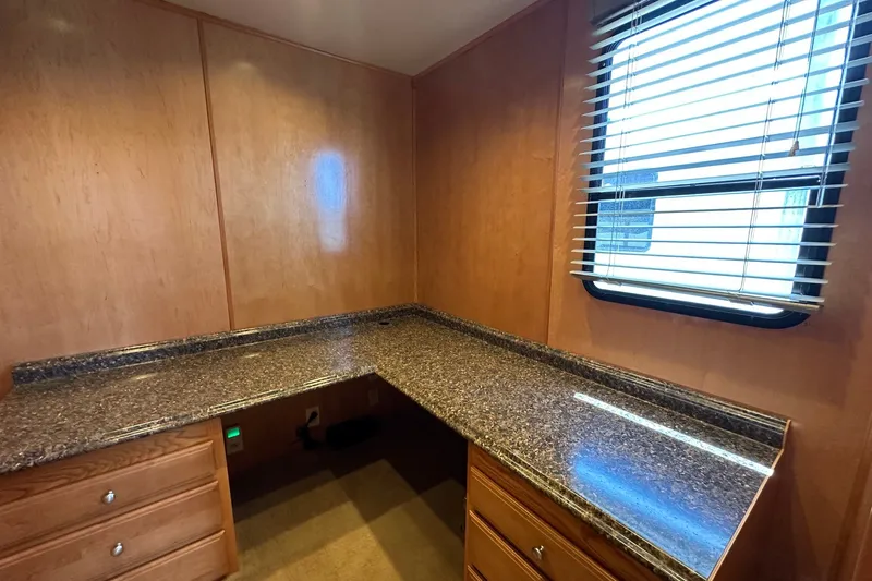 Slide: The Image of Wood-paneled room with granite countertop and window blinds in a 2003 Sumerset 18x86. - 11
