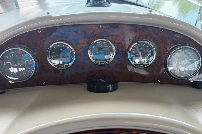 Slide: The Image of Dashboard of a 2004 Sea Ray Sundancer 320 boat with multiple gauges. - 33