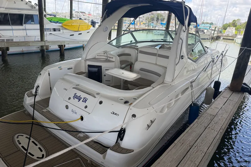 Slide: The Image of 2004 Sea Ray Sundancer 320 docked, featuring spacious seating and sleek design. - 17