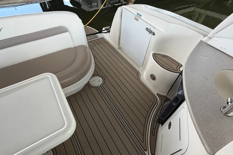 Slide: The Image of 2004 Sea Ray Sundancer 320 boat interior with seating and kitchenette area. - 26