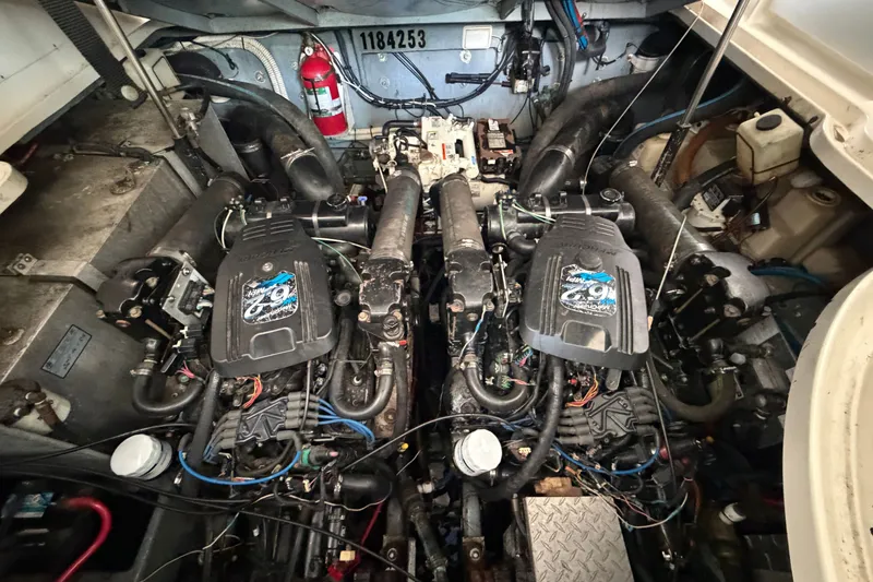 Slide: The Image of Engine compartment of a 2004 Sea Ray Sundancer 320, featuring dual engines and mechanical components. - 51