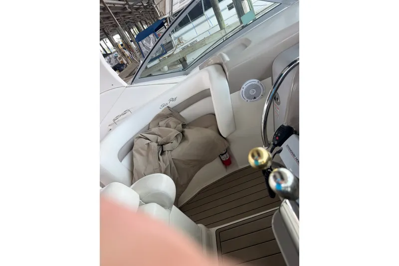 Slide: The Image of Interior of a 2004 Sea Ray Sundancer 320 boat, featuring seating and controls. - 37