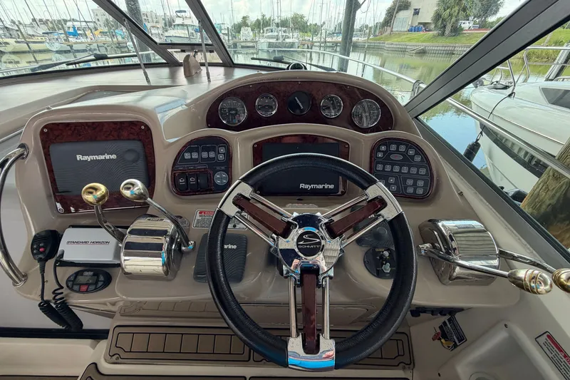 Slide: The Image of Helm of 2004 Sea Ray Sundancer 320 with Raymarine electronics and steering wheel. - 31