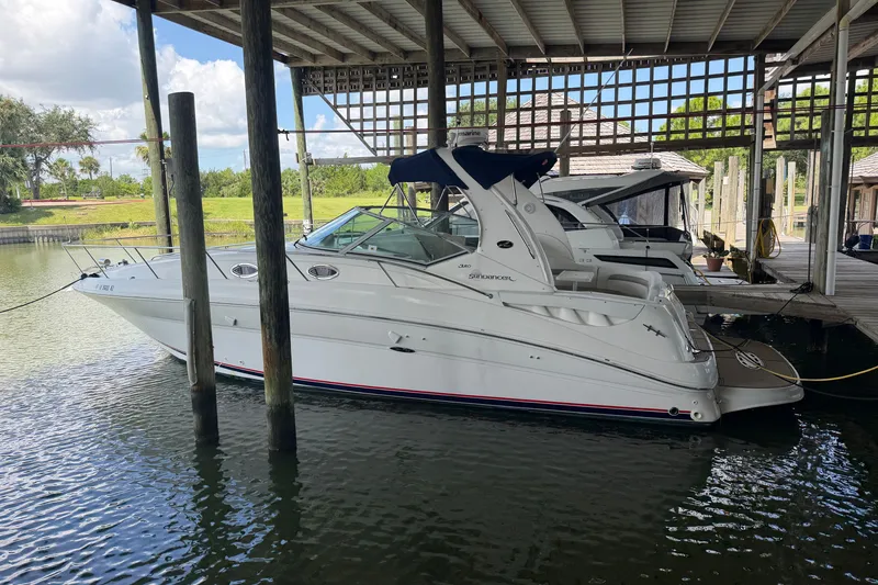 The Image of 2004 Sea Ray Sundancer 320 docked in a covered marina, showcasing sleek design and luxury features. - 0