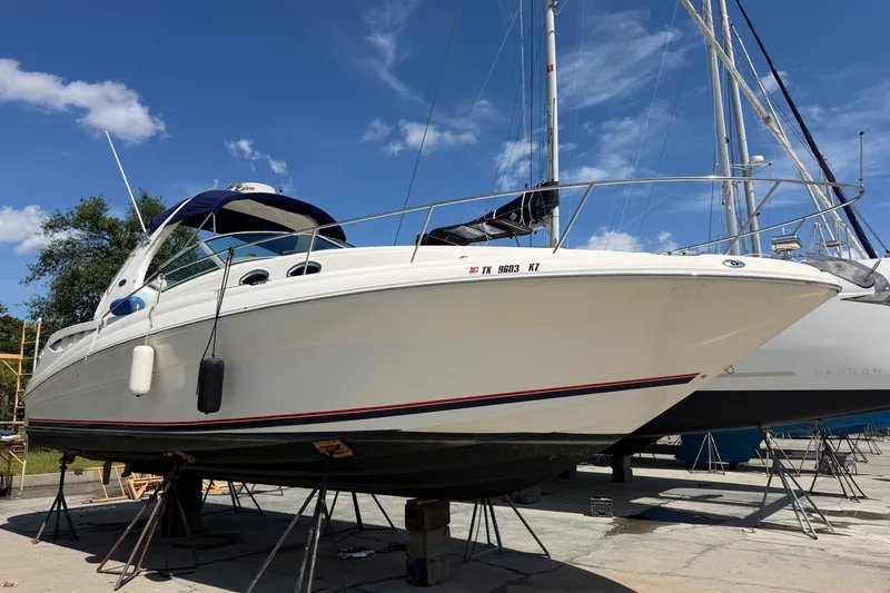 Slide: The Image of 2004 Sea Ray Sundancer 320 yacht on stands under a clear blue sky. - 8