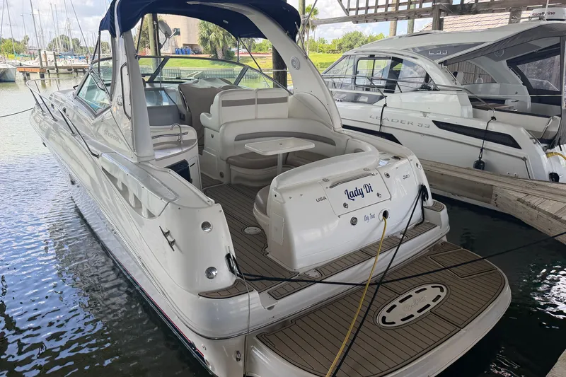 Slide: The Image of 2004 Sea Ray Sundancer 320 docked, featuring spacious seating and elegant design. - 19