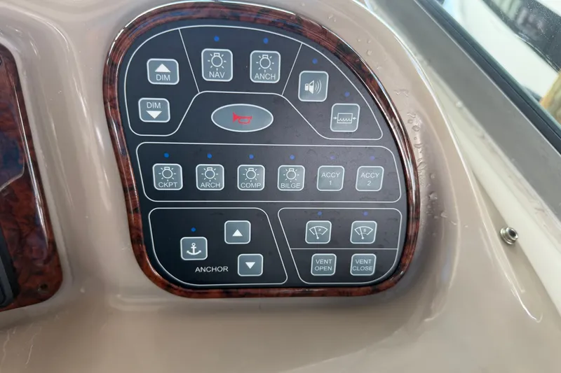 Slide: The Image of Control panel of a 2004 Sea Ray Sundancer 320 boat with various function buttons. - 34