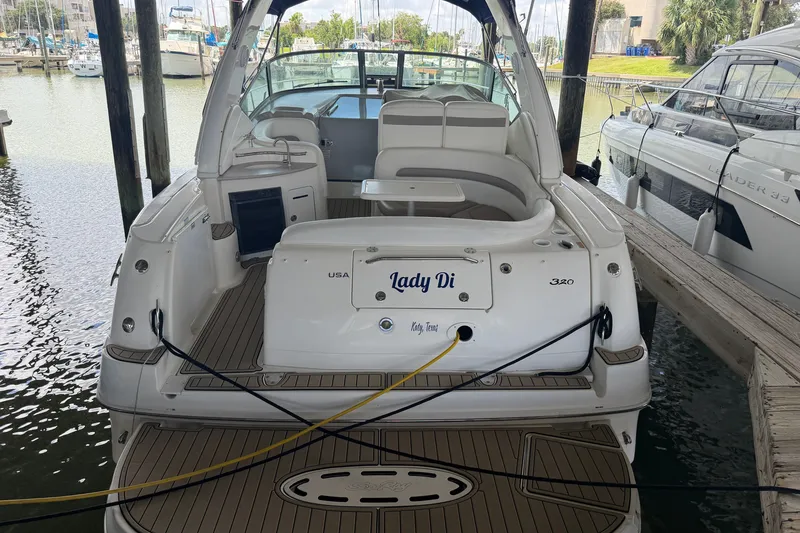 Slide: The Image of 2004 Sea Ray Sundancer 320 docked, rear view with seating and deck details. - 18