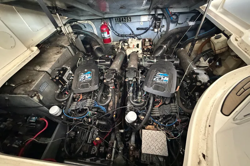 Slide: The Image of Engine compartment of a 2004 Sea Ray Sundancer 320 with dual engines and fire extinguisher. - 49