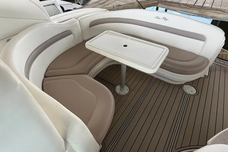 Slide: The Image of 2004 Sea Ray Sundancer 320 boat interior with curved seating and table. - 25