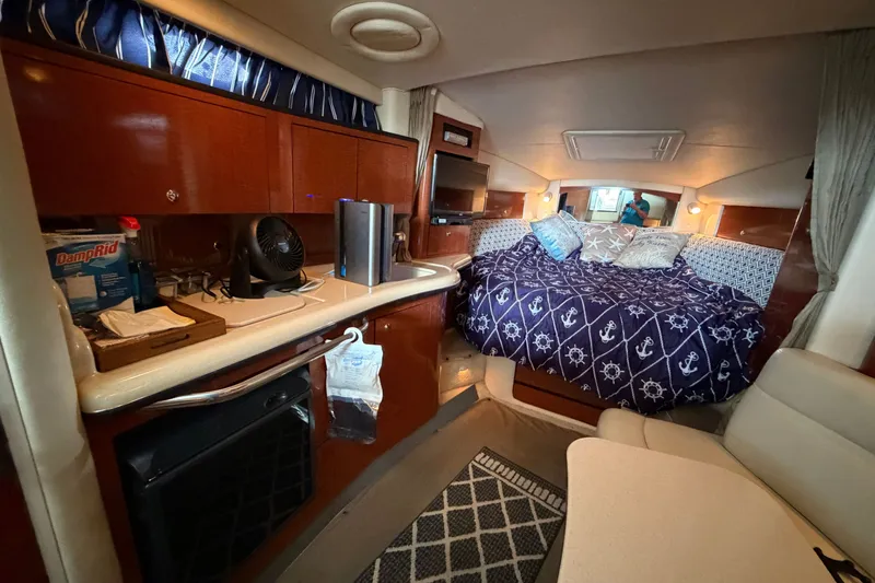 Slide: The Image of Interior of 2004 Sea Ray Sundancer 320 with cozy bed and elegant wood cabinetry. - 43