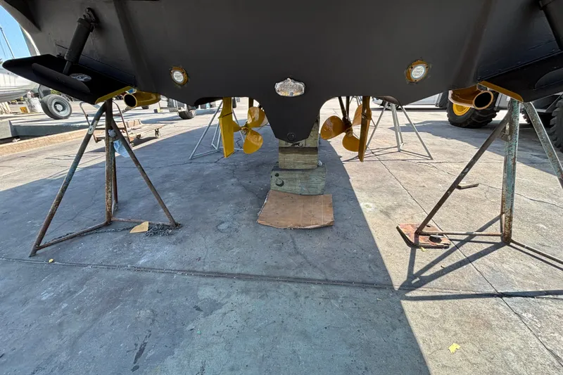 Slide: The Image of 2004 Sea Ray Sundancer 320 boat hull and propellers on dry dock. - 12