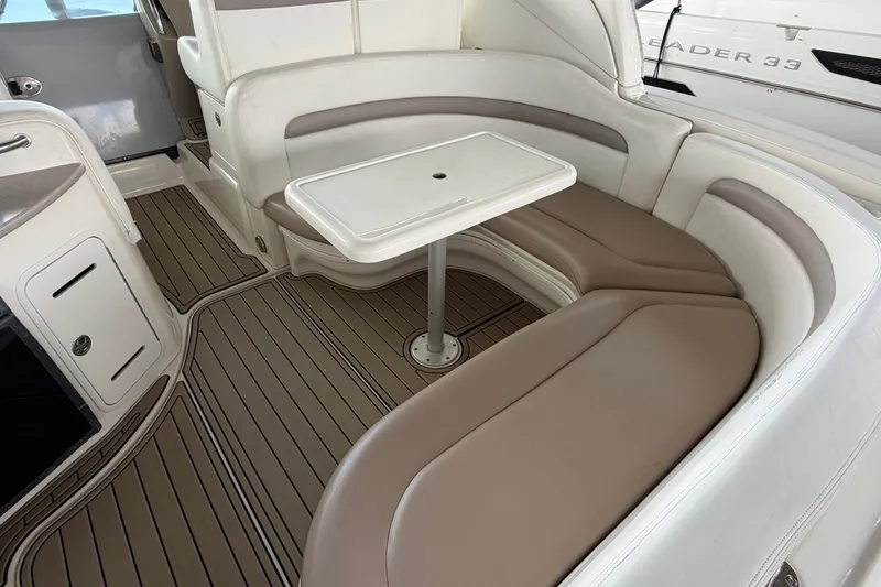 Slide: The Image of Luxurious 2004 Sea Ray Sundancer 320 interior with elegant seating and table arrangement. - 27