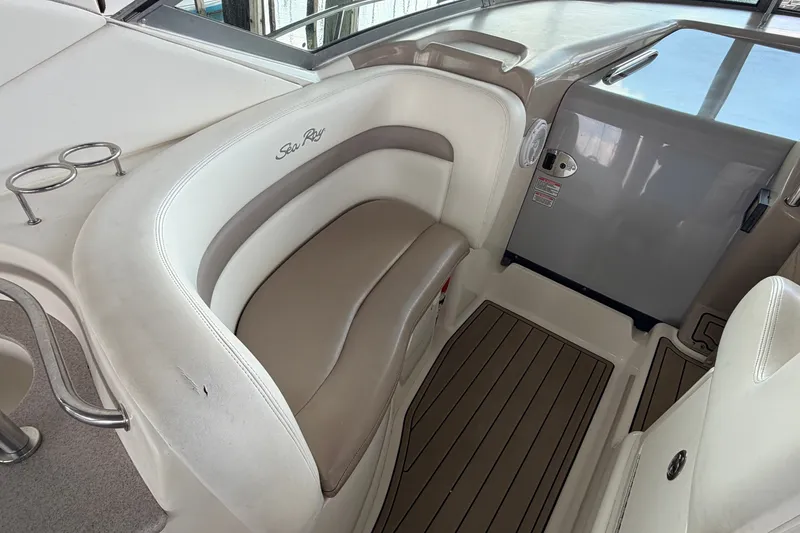 Slide: The Image of 2004 Sea Ray Sundancer 320 interior with cushioned seating and cup holders. - 29
