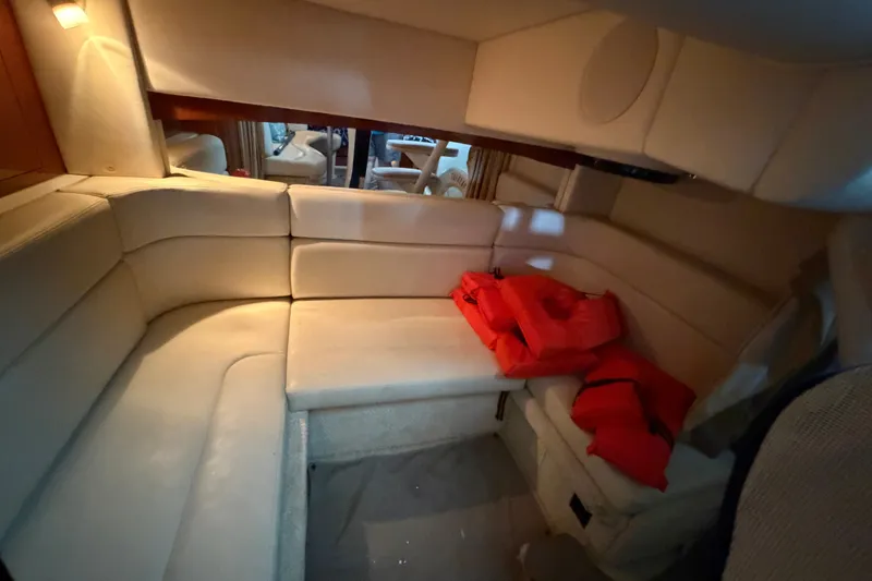 Slide: The Image of Interior of 2004 Sea Ray Sundancer 320 with beige seating and life jackets. - 45