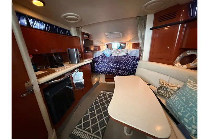 Slide: The Image of Interior of 2004 Sea Ray Sundancer 320 yacht with cozy cabin and dining area. - 46