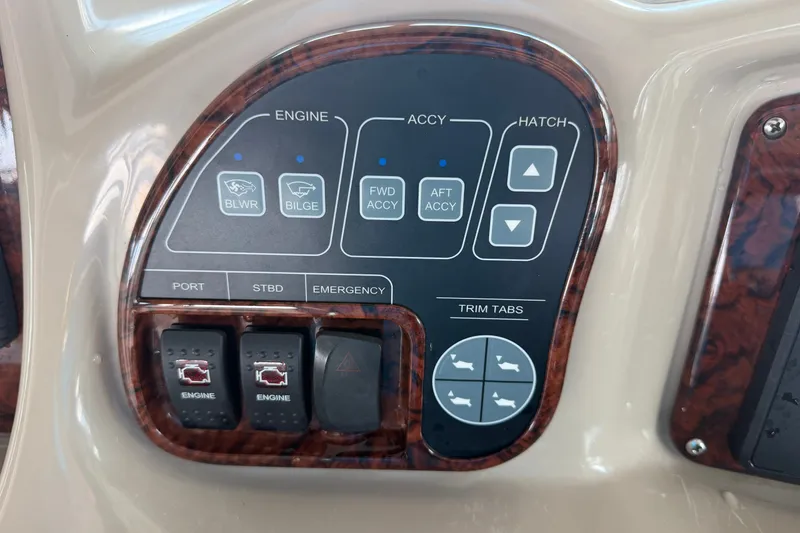 Slide: The Image of Control panel of a 2004 Sea Ray Sundancer 320 boat with engine and trim tab switches. - 35