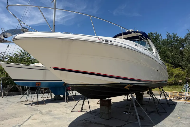 Slide: The Image of 2004 Sea Ray Sundancer 320 yacht on dry dock under clear blue sky. - 5