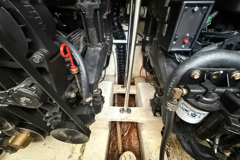 Slide: The Image of Engine compartment of a 2000 Larson Cabrio 330 boat, showcasing mechanical components. - 56