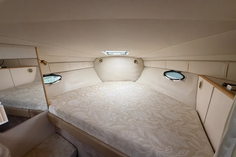 Slide: The Image of Interior cabin of 2000 Larson Cabrio 330 boat with elegant beige bedding. - 41