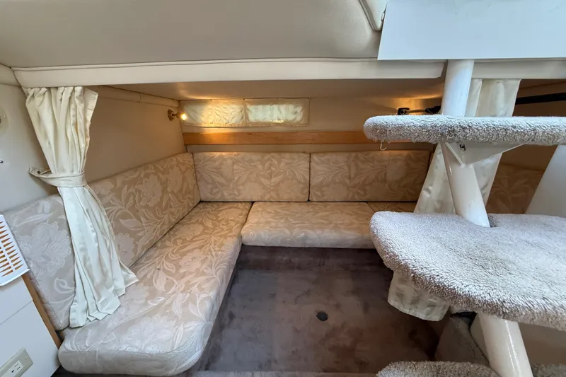 Slide: The Image of Interior of 2000 Larson Cabrio 330 boat with cozy seating and carpeted stairs. - 45