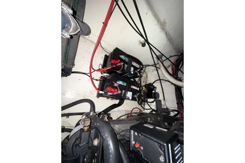 Slide: The Image of Engine compartment of a 2000 Larson Cabrio 330 with visible batteries and wiring. - 59