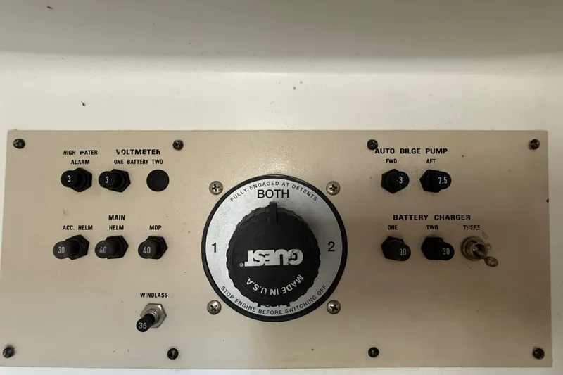 Slide: The Image of Control panel of a 2000 Larson Cabrio 330 boat with various switches and dials. - 61