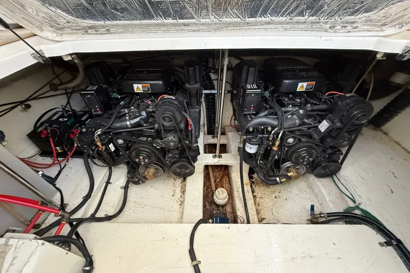 Slide: The Image of Engine compartment of a 2000 Larson Cabrio 330 boat, showcasing dual engines. - 52