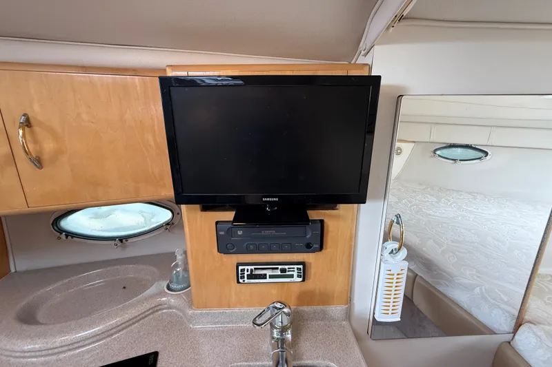 Slide: The Image of Interior of 2000 Larson Cabrio 330 with TV, sink, and porthole window. - 37