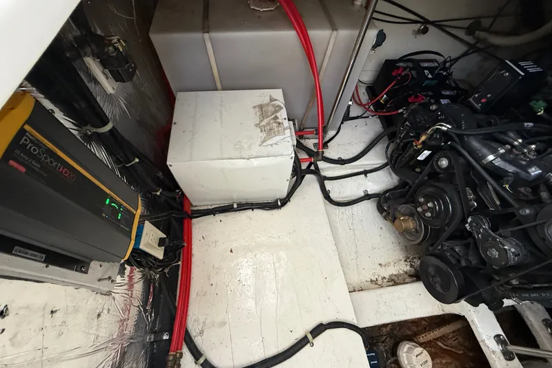 Slide: The Image of Engine compartment of a 2000 Larson Cabrio 330 boat, showing wiring and components. - 53