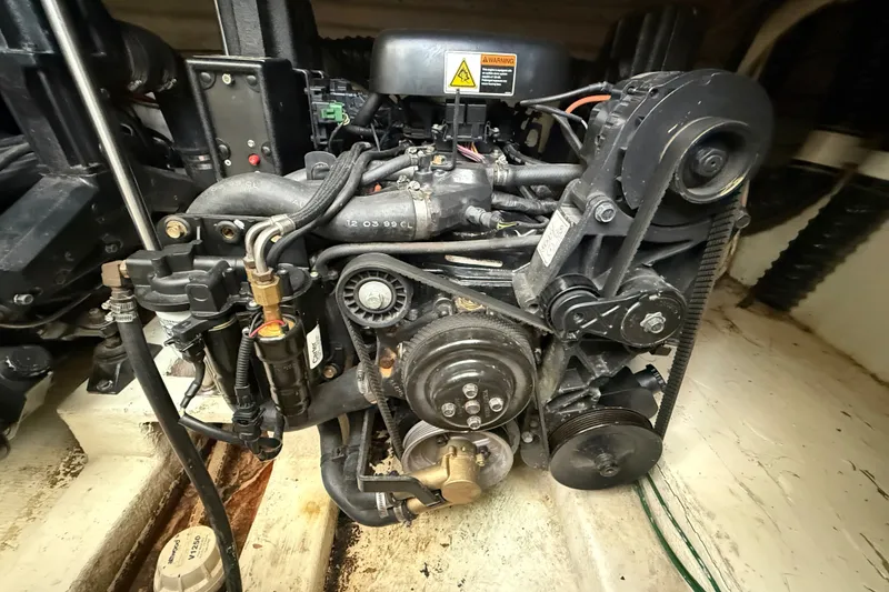 Slide: The Image of Engine compartment of a 2000 Larson Cabrio 330 boat, showcasing mechanical components. - 55