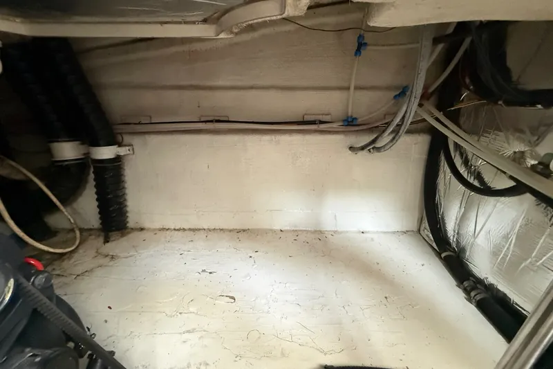 Slide: The Image of Engine compartment of a 2000 Larson Cabrio 330 boat, showing wiring and hoses. - 60