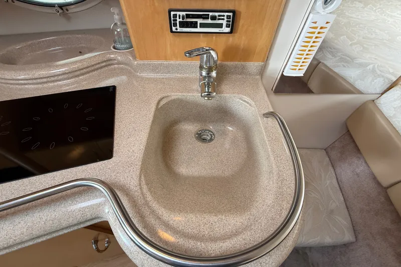 Slide: The Image of 2000 Larson Cabrio 330 boat interior with sink and control panel. - 36