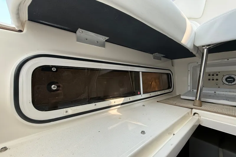 Slide: The Image of Interior view of a 2000 Larson Cabrio 330 boat, showcasing window and control panel. - 62