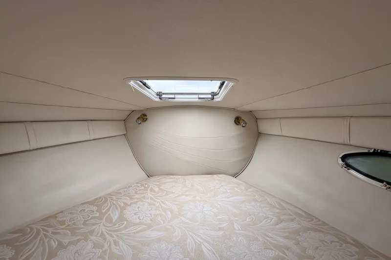 Slide: The Image of Interior cabin of 2000 Larson Cabrio 330 boat with floral-patterned bedding. - 43