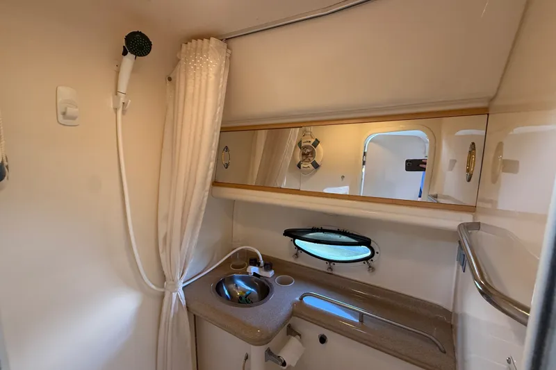 Slide: The Image of 2000 Larson Cabrio 330 boat bathroom with shower, sink, and mirror. - 49