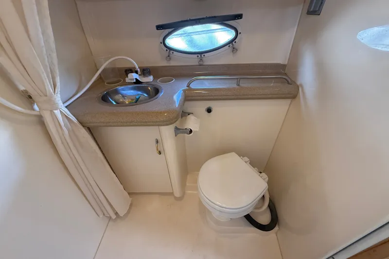 Slide: The Image of Bathroom interior of 2000 Larson Cabrio 330 boat with sink and toilet. - 50