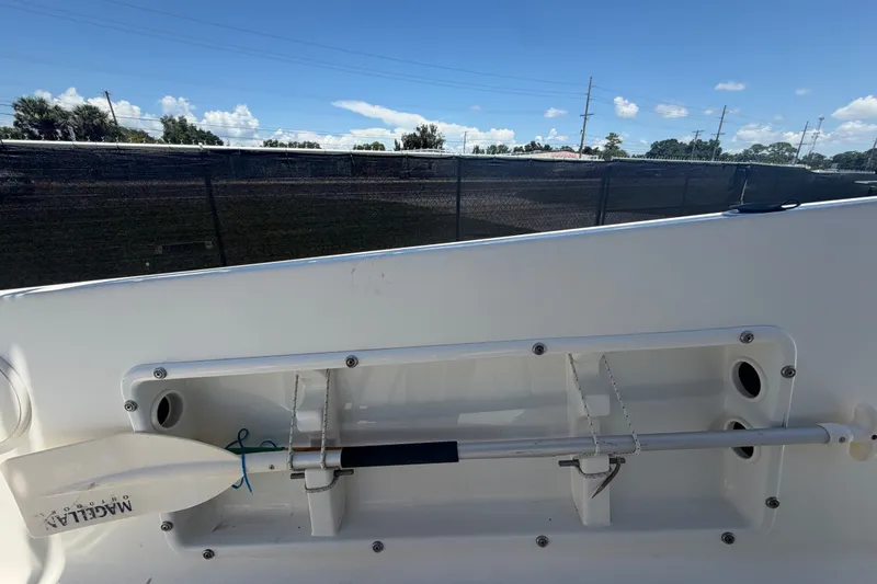 Slide: The Image of 2022 Key Largo 180 Center Console boat with paddle storage, clear sky background. - 41