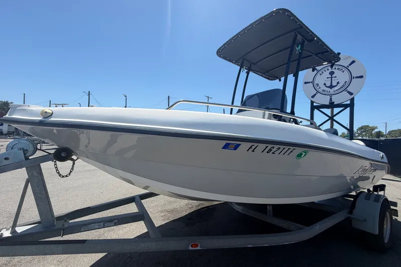 Slide: The Image of 2022 Key Largo 180 Center Console boat on trailer under clear blue sky. - 7