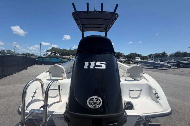 Slide: The Image of 2022 Key Largo 180 Center Console boat with 115 horsepower engine, parked outdoors. - 3