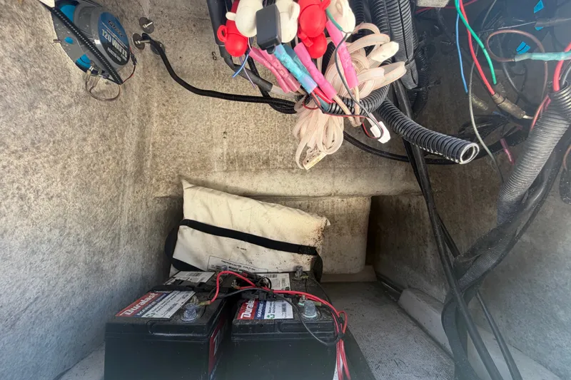 Slide: The Image of Electrical wiring and batteries inside a 2022 Key Largo 180 Center Console boat. - 24