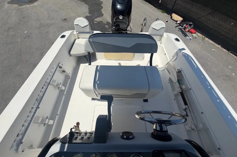 Slide: The Image of The image shows the cockpit of a 2022 Key Largo 180 Center Console boat with helm and seating. - 39