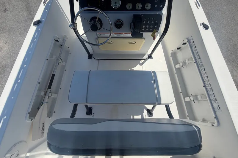 Slide: The Image of The image shows the cockpit of a 2022 Key Largo 180 Center Console boat with helm and seating. - 14
