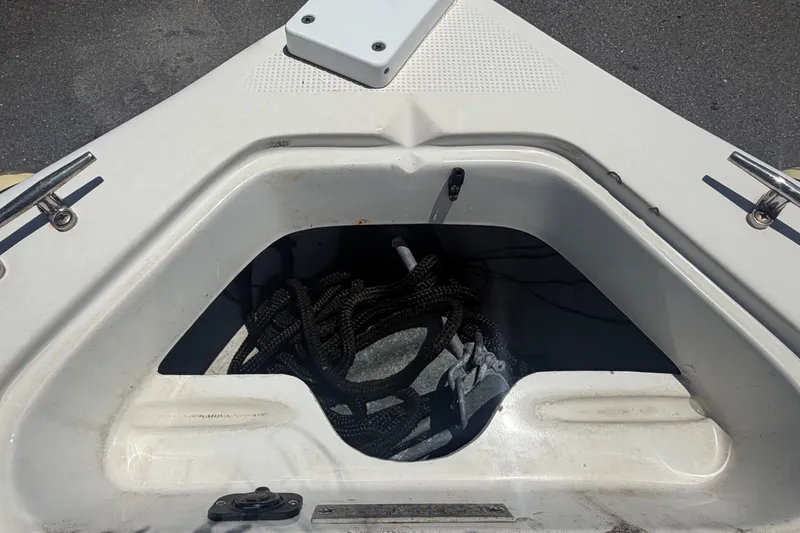Slide: The Image of An open storage compartment in the bow of a Key Largo 180 Center Console boat with ropes and anchor. - 31