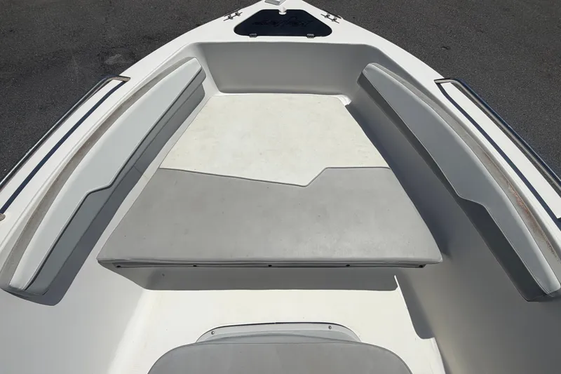 Slide: The Image of 2022 Key Largo 180 Center Console boat interior with cushioned seating and storage. - 26